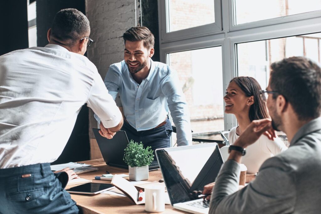 Colleagues shaking hands during a team meeting